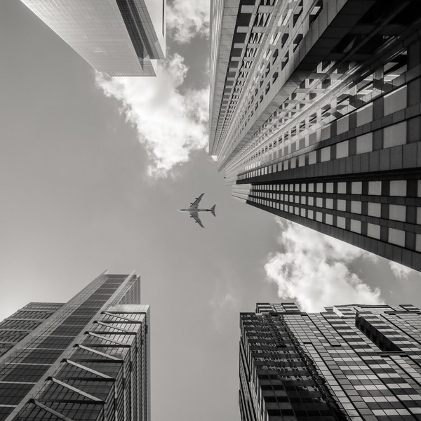 buildings city plane sky