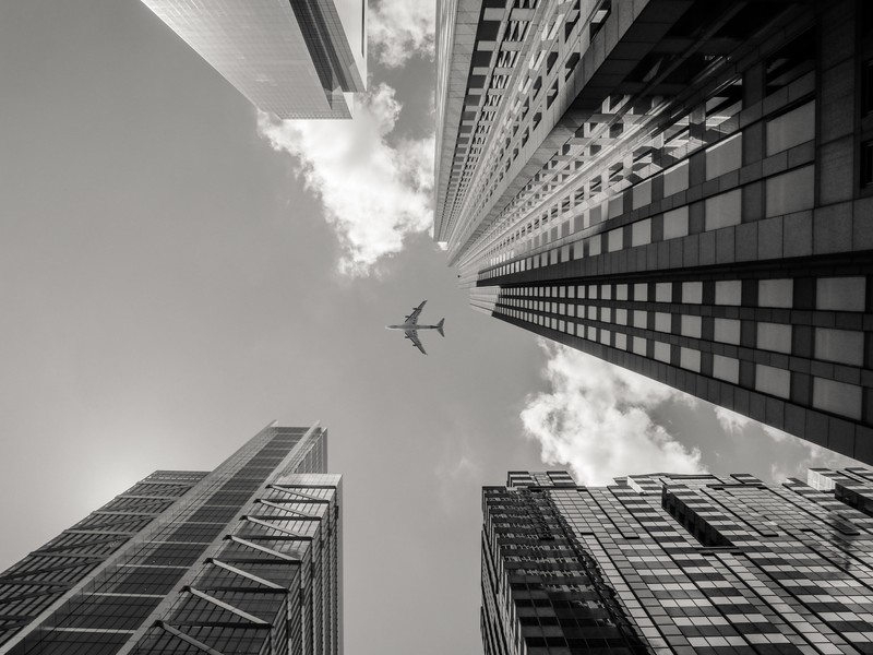 buildings city plane sky