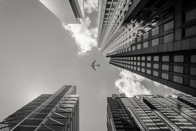 buildings city plane sky