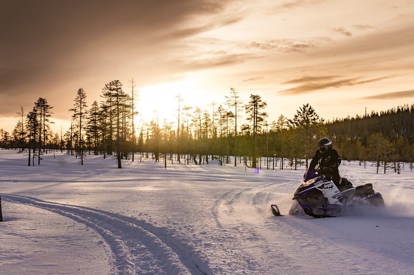 snowmobiling and sunset in finland